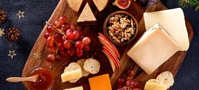 Christmas,Cheese,Platter,With,Grapes,,Nuts,,Figs,On,A,Dark